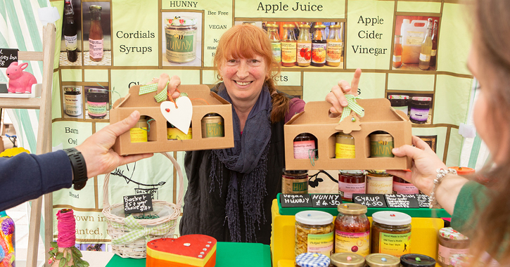Jenny owner of Dalton Moor Farm on a market stall selling her vegan produce.